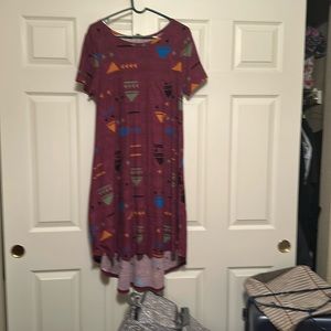 Carly Dress, leggings material the background is a plum color.